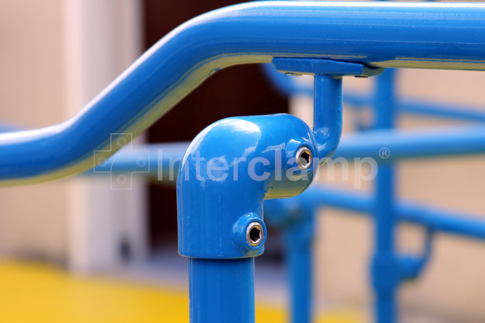 Close-up of Interclamp key clamp DDA Assist fittings forming a secure and compliant handrail along a school corridor, promoting safe navigation for students and staff.